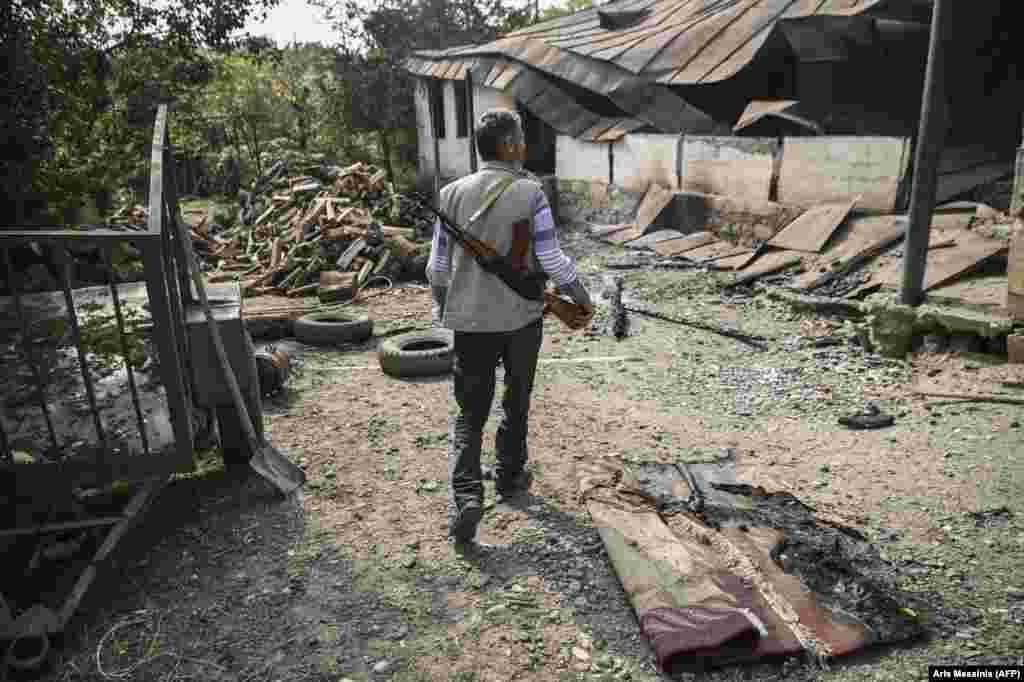 A villager arrives at a neighbor’s destroyed home in the Martakert region of Nagorno-Karabakh on October 15.