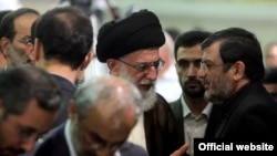 The daughter of Ayatollah Ruhollah Khomeini is urging Iran's Supreme Leader Ayatollah Ali Khamenei (center) to reinstate the candidacy of former President Ali Akbar Hashemi Rafsanjani.