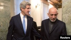 Afghan President Hamid Karzai (right) with US Secretary of State John Kerry (file photo)