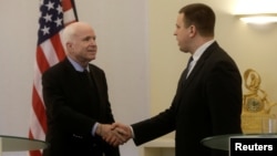 U.S. Senator John McCain shakes hands with Estonia's Prime Minister Juri Ratas in Tallinn, Estonia, on December 27.