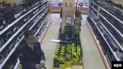 A TV grab shows former police officer Denis Yevsyukov reloading his pistol in a Moscow supermarket on April 27, 2009.