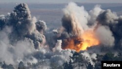 Smoke rises over the Syrian town of Kobani after an air strike as seen from the Turkish-Syrian border.