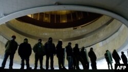 Vigilantes on both sides of the divide in Ukraine have formed groups to protect buildings that they control. In this picture, antigovernment activists protect Kyiv's "Ukrainian House," which was seized by protesters on January 26.