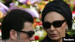 Alireza Pahlavi with his mother at the funeral for the prince of Monaco in Monte Carlo in 2005