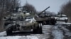 Destroyed Russian tanks line a road in the Sumy region. 