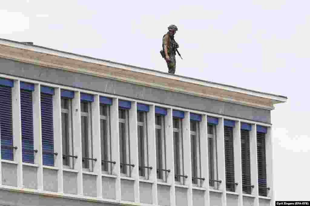 A soldier stands on the roof of a building near Geneva airport on June 15. 
