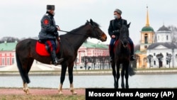 Cossack volunteers, wearing face masks to protect against the coronavirus, patrol the Palace of Kuskovo in Moscow on April 8.
