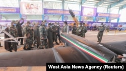 Top Iranian military commanders inspect domestically manufactured military drones unveiled at an exhibition in Semnan in January 2021.