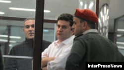 Georgian former Interior Minister Bacho Akhalaia (center) in police custody.