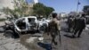 Free Syrian Army fighters inspect damaged cars after a car bomb in Azaz, Syria, in September 2018.