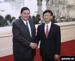 Publicity-shy Rustam Inoyatov (left), the chief of the National Security Committee, is seen during a trip to China in 2014.
