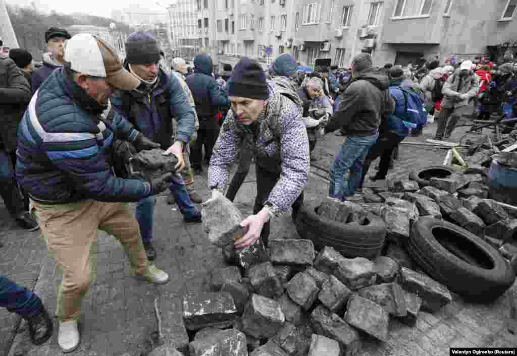 Protesters stack paving stones as the standoff grows. 