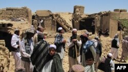 Villagers search for dead bodies of those killed in a NATO air strike in the village of Sajawand in Logar Province on June 6.