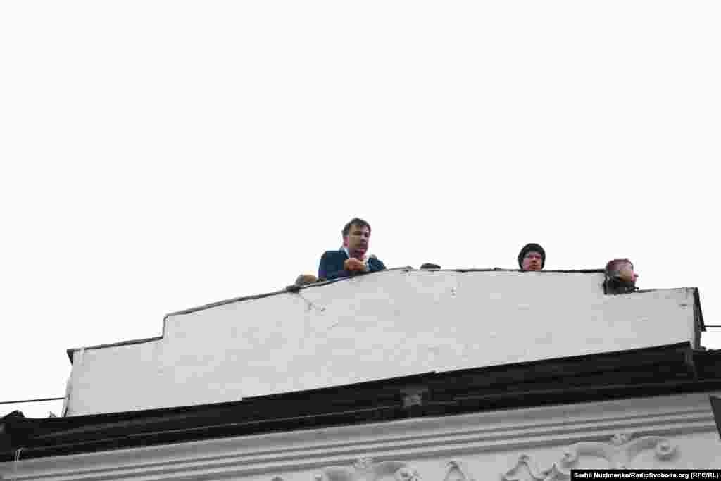 Mikheil Saakashvili, the former president of Georgia, ex-governor of Ukraine's Odesa region, and opponent of Ukraine's President Petro Poroshenko, shouts to supporters from the roof of the apartment building where he had been staying. 