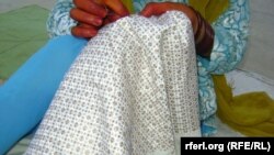 A woman stitches traditional Khamak embroidery in Afghanistan's Kandahar Province. The embroidery has become a "nice employment opportunity" for women in the region.