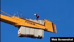 Tajik migrant on crane