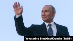 Russian President Vladimir Putin waves to the public after his fourth inauguration as president on May 7.