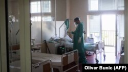 A medical worker treats a patient suffering from COVID-19 at a hospital in Belgrade on July 14.