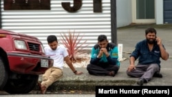 Members of the public react following a deadly mass shooting at the Al Noor mosque in Christchurch, New Zealand, on March 15.