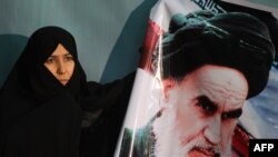 An Iranian woman marks the anniversary of the 1979 return to Tehran of Ayatollah Khomeini.