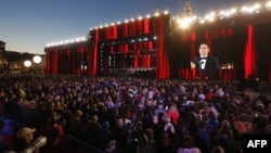 Guests listen to Peruvian tenor Juan Diego Florez during a gala-concert dedicated to the World Cup soccer tournament, on Moscow's Red Square on June 13.