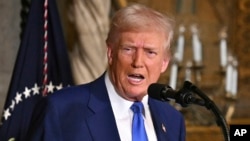 U.S. President Donald Trump speaks to reporters at his Mar-a-Lago resort in Florida on February 18.