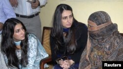 The daughter and wife of the governor of Punjab Province speak to Aasia Bibi (right), who has been sentenced to death for blasphemy