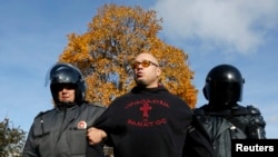 Police detain an antigay protester who took part in a gathering to prevent gay rights activists from staging a protest in St. Petersburg on October 12.