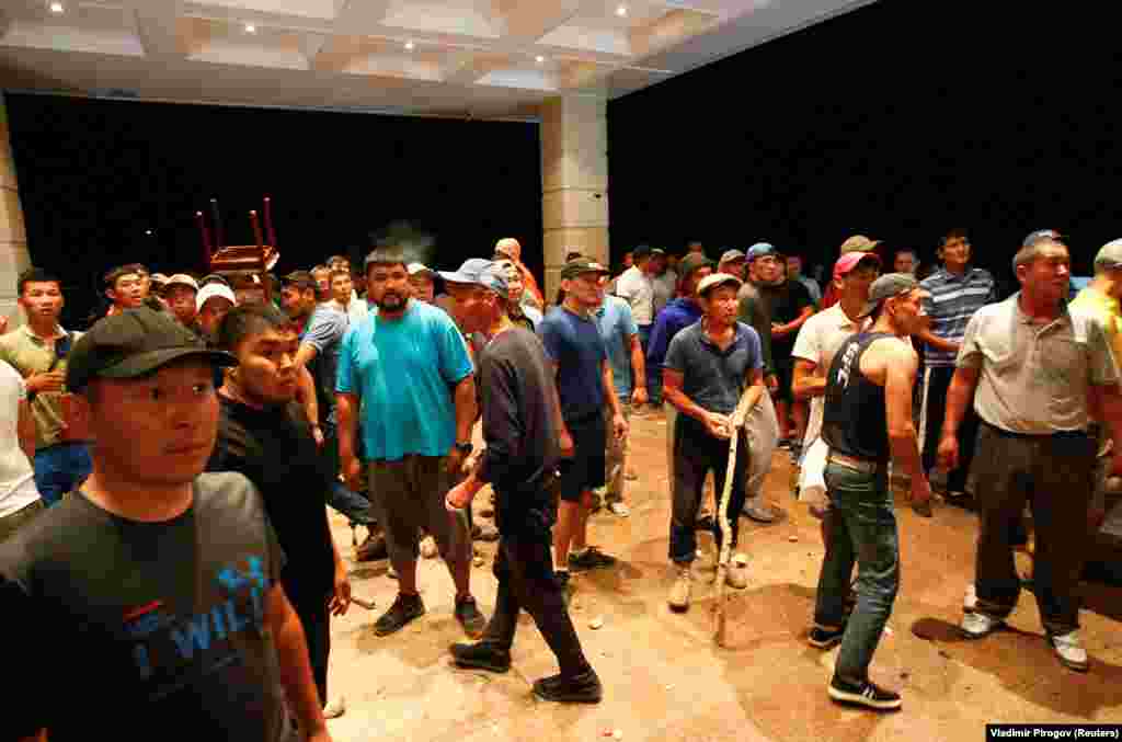 Supporters gather at the entrance to a building in the compound. 