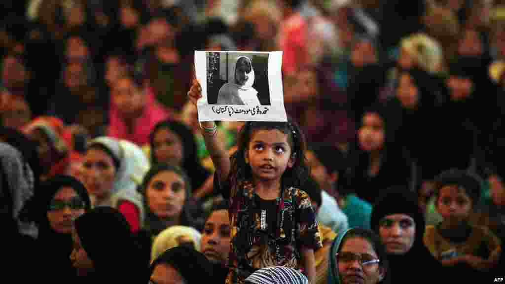 A girl holds a photograph of Malala during a rally in Karachi.