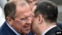 Serbian Foreign Minister Ivica Dacic (right) welcomes his Russian counterpart Sergei Lavrov at Belgrade's airport on June 16.