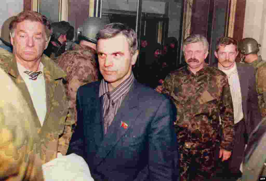Former parliament chairman Ruslan Khasbulatov (second from left) and former Vice President Aleksandr Rutskoi (third from right) being escorted from the parliament building on October 4. 
