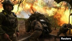 Ukrainian serviceman fire a howitzer at Russian positions on the front line near the town of Soledar in the Donetsk region on May 6.