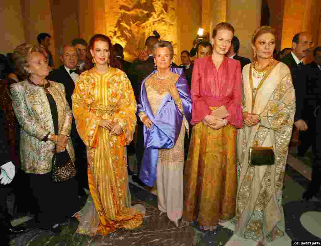 Bernadette Chirac, the wife of French President Jacques Chirac (left), Princess Lalla Salma of Morocco (second from left), Children's Foundation President Anne-Aymone Giscard d'Estaing (center), Princess Mathilde of Belgium (second from right), and former Iranian Empress Farah Pahlavi (right) pose as they arrive at the Palace of Versailles in France to attend a charity gala in December 2003.