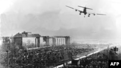 A U.S. transport aircraft flies over Berlin's Tempelhof Airport in June 1948