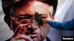 A Pakistani man places a shoe on an image of former President Pervez Musharraf during a protest in Quetta last month.
