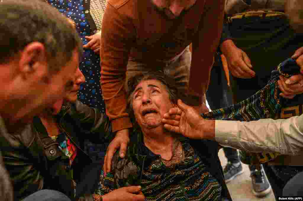 Relatives of Royal Sahnazarov, Zuleyha Sahnazarova, and their daughter Medine Sahnazorava, who were killed when a rocket hit their home in Ganca, mourn during their funeral on October 17.    
