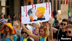 A woman wearing the colors of the Ukrainian flag takes part in a protest rally in Helsinki on July 15, one day before a planned meeting between U.S. President Donald Trump and Russian President Vladimir Putin in the Finnish capital.