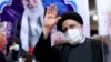 Ebrahim Raisi waves to journalists while registering his candidacy for the upcoming presidential election at the Interior Ministry in Tehran on May 15.