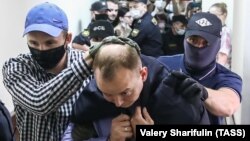 Former Russia journalist Ivan Safronov is escorted to a hearing at a Moscow court on "treason" charges earlier this week.