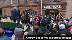Pictured here standing on a truck in a knee-length, brown-leather jacket at the opening of one of his food stores, Russian businessman German Sterligov has sparked controversy by displaying homophobic signs on his premises.