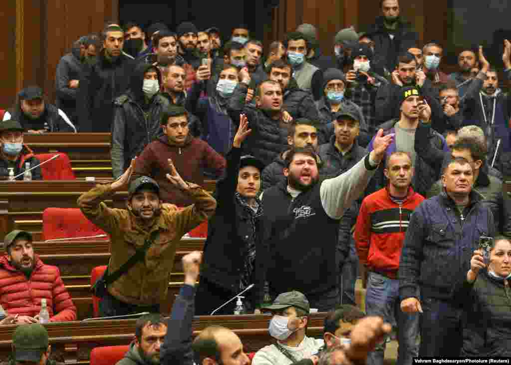 Demonstrators shout inside the parliament building. Parliament speaker Ararat Mirzoyan was  hospitalized after being attacked during the protests. 