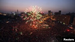 Fireworks explode as supporters of Muslim Brotherhood's presidential candidate Muhammad Morsi celebrate his victory in the election on Tahrir Square in Cairo on June 24