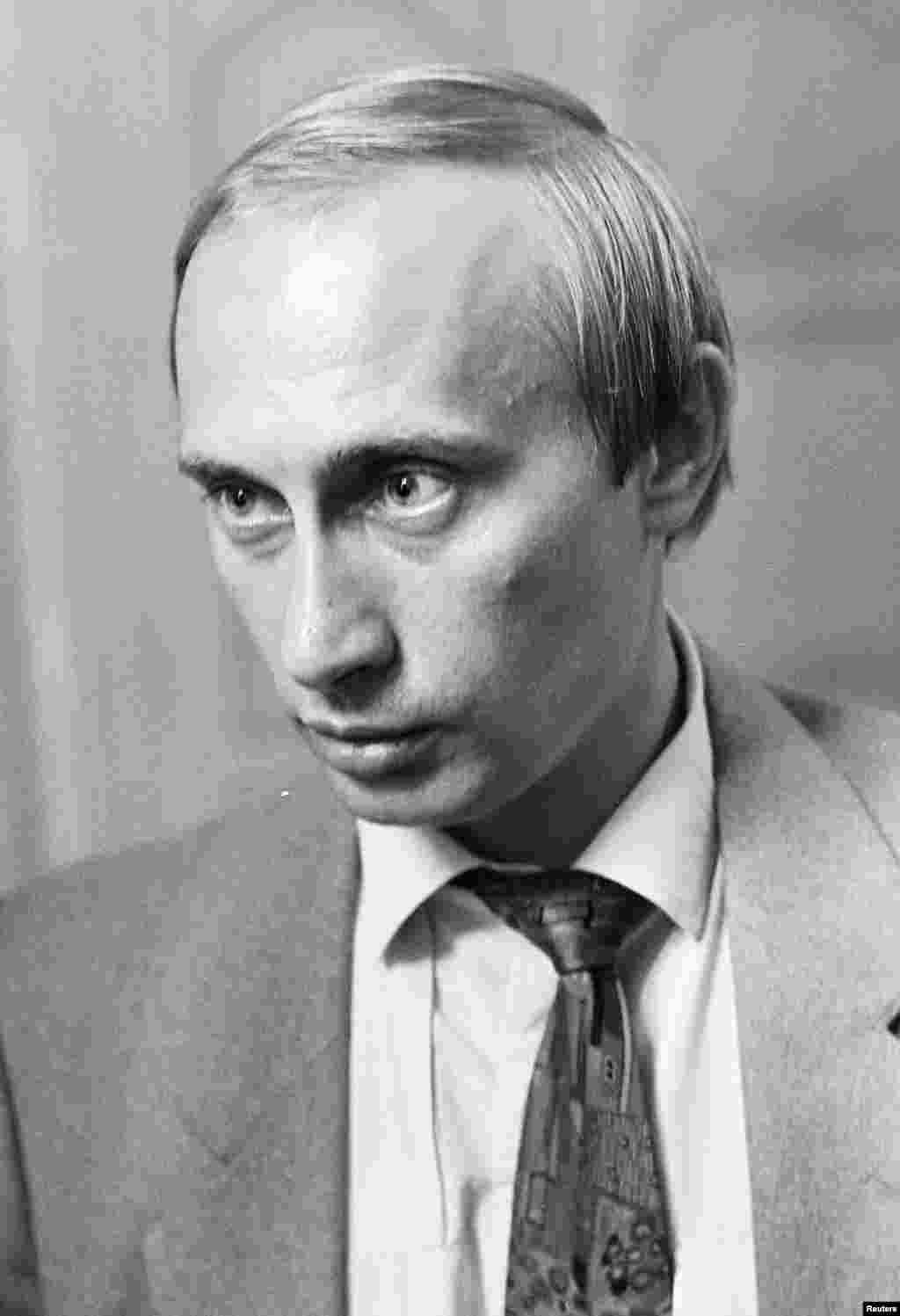Vladimir Putin, chairman of St. Petersburg's External Relations Committee, looks on at Mariinsky Palace in St. Petersburg on August 20, 1991.