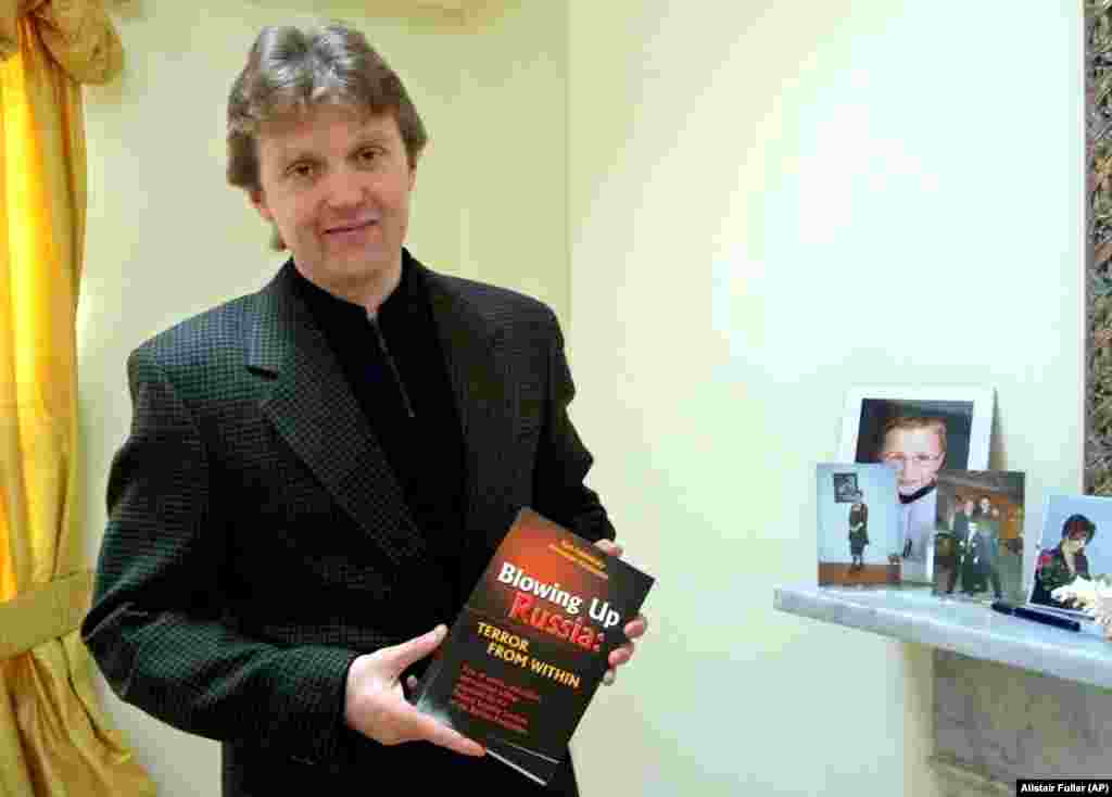 Litvinenko poses with his book, Blowing Up Russia: Terror From Within, at his home in London in May 2002. In the book, he accused the Russian secret services of staging the Russian apartment bombings in 1999 and other acts of terrorism in an effort to bring Vladimir Putin to power.  Litvinenko fled Russia in 1999 after revealing an alleged plan by the FSB to kill tycoon Boris Berezovsky.   