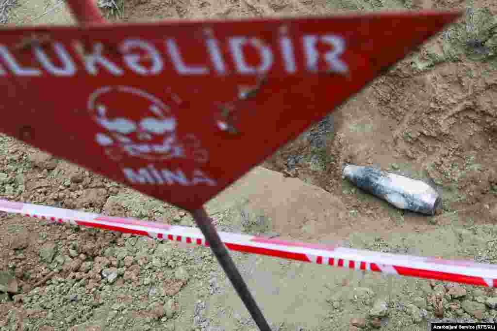 A phosphorus shell that Azerbaijani authorities say was left behind by ethnic Armenian forces lies cordoned off from onlookers. 