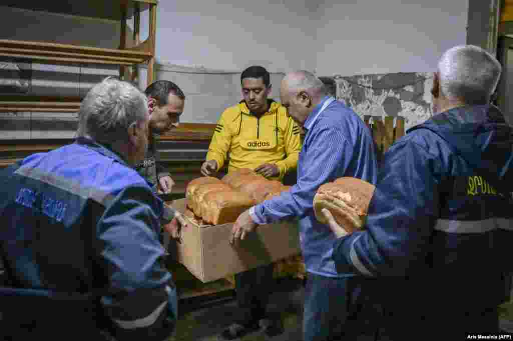 Stepanakert residents pick up bread from the bakery.  