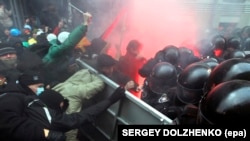 Protesters try to break through a riot police line near the presidential administration building during a rally by EU supporters in Kyiv on December 1.