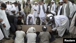 Mourners bury Kandahar City Mayor Ghulam Haidar Hamidi, one of the region's most trusted public servants, who was assassinated last month.