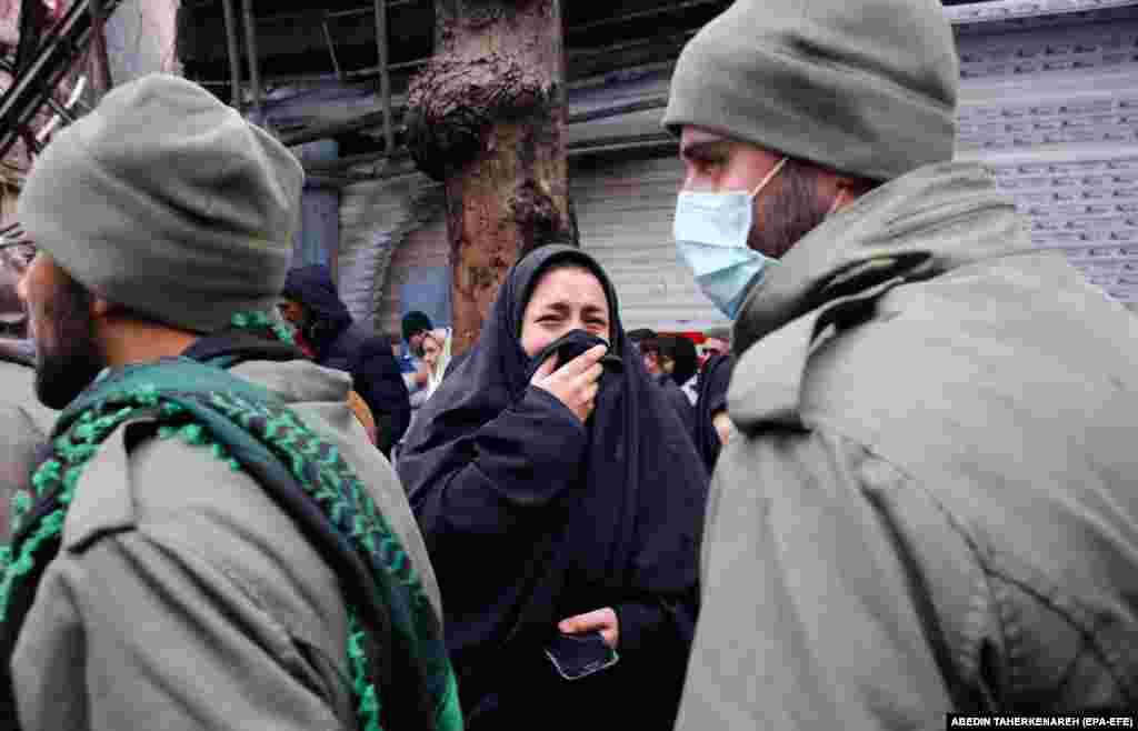 A woman mourns during the funeral of an Iranian security officer in Shahriar. 
